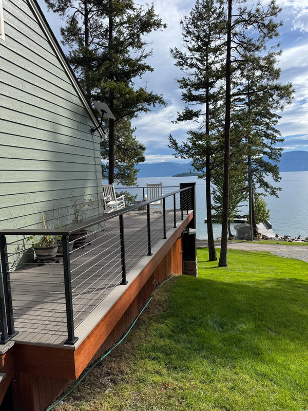 Side view of black square-post cable railing along the deck