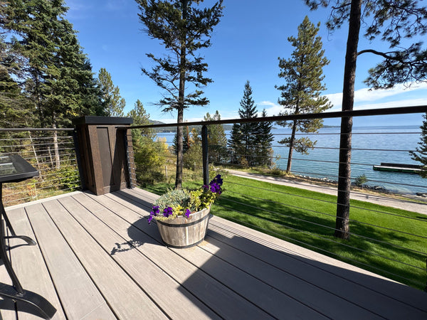 Black cable railing at a deck corner with a planter