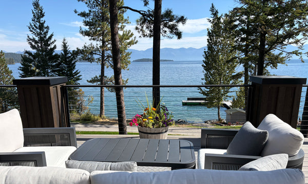 Outdoor seating beside a black cable railing