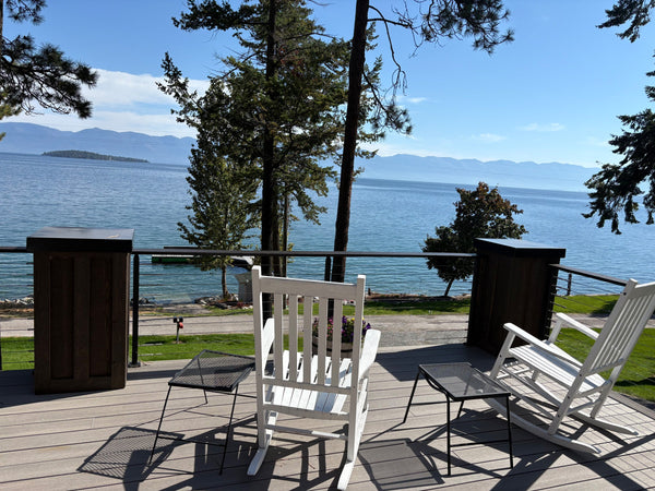 Rocking chairs facing a view through cable railing