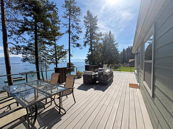Outdoor dining and seating on an elevated deck with black cable railing